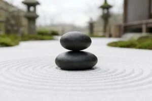 砂紋の上に黒い石が二つ積まれた写真。本当にすごい人は自慢しない心理を語るイメージ